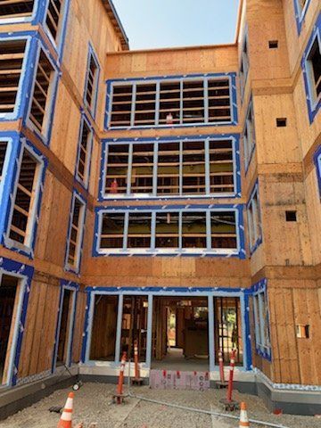 A large building under construction with a lot of windows.