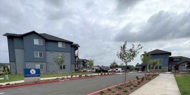 A row of apartment buildings sitting next to each other on a cloudy day.