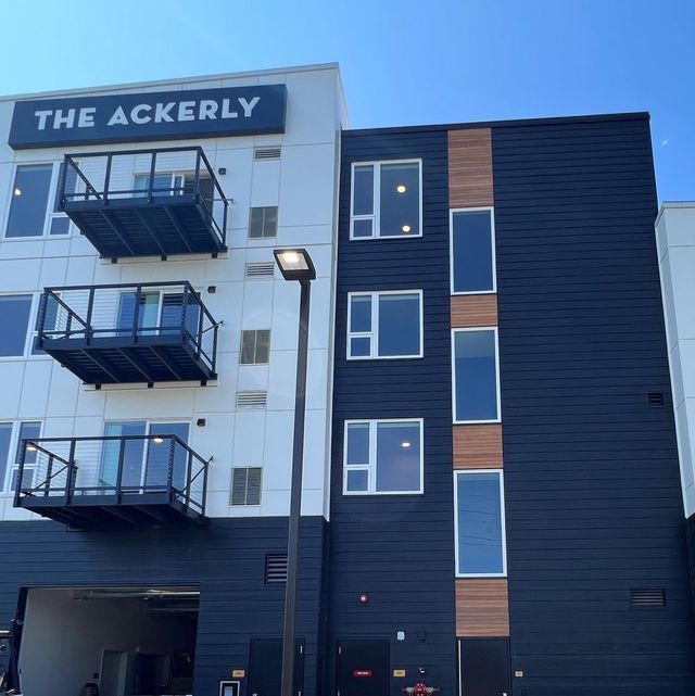 A building with a sign that says the ackerly