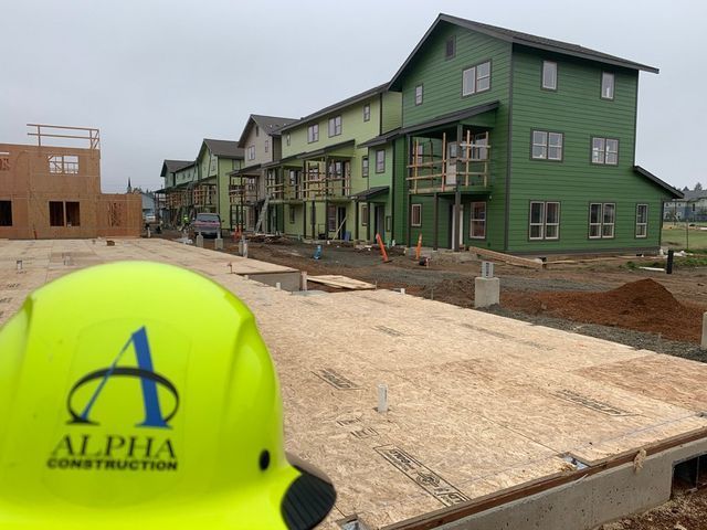 A yellow helmet with alpha construction written on it