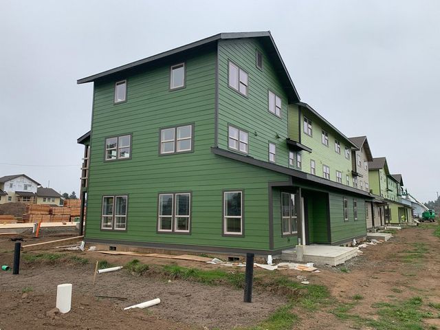A green building with a lot of windows is being built.