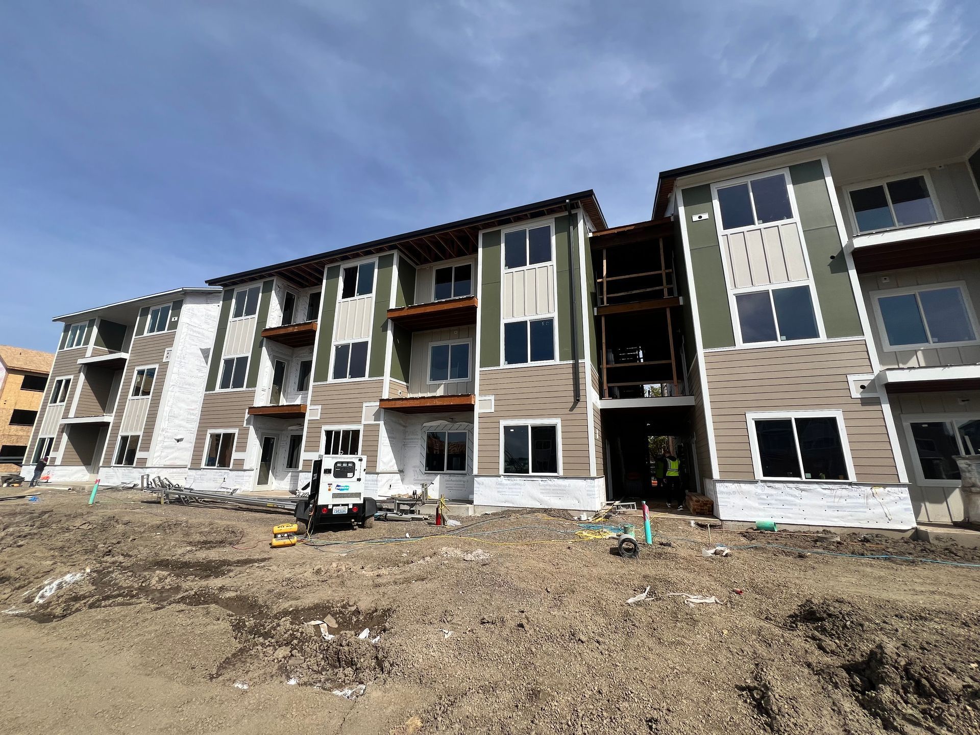 A large apartment building under construction with a lot of windows.