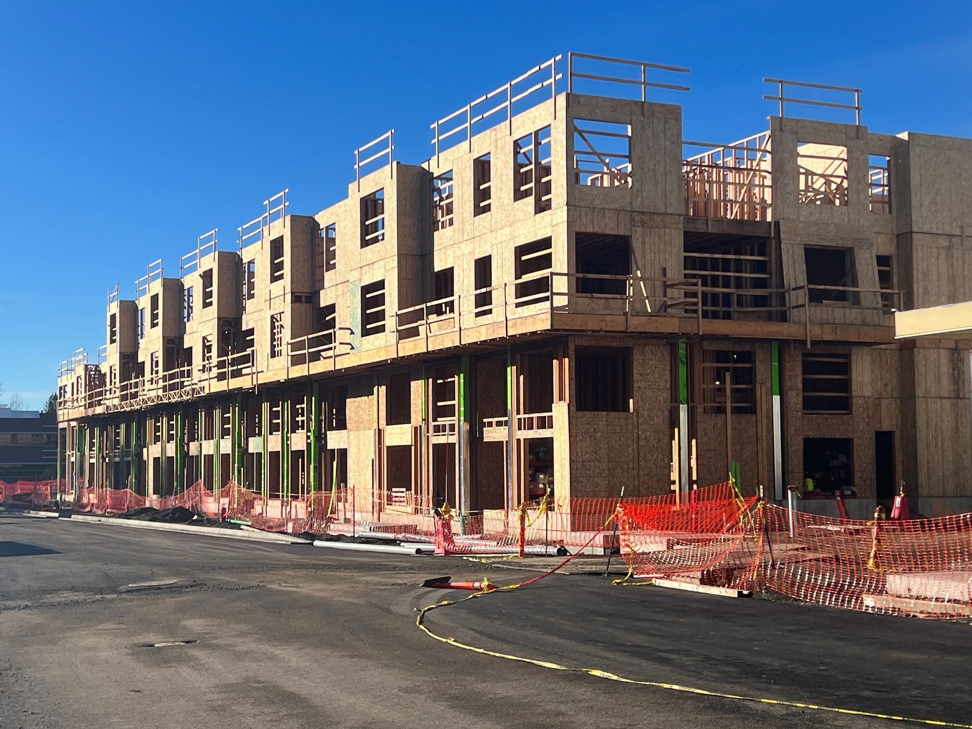 A large building under construction with a blue sky in the background