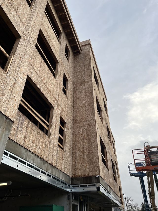 A large building under construction with a blue sky in the background