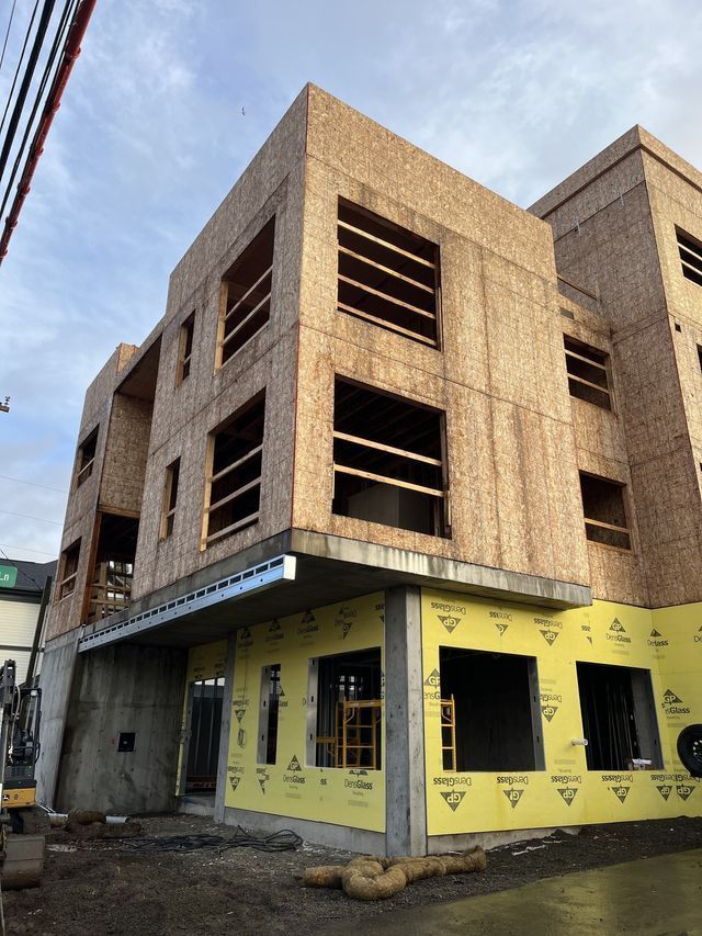 A large building under construction with a lot of windows.