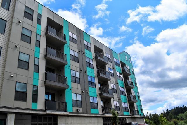 A large apartment building with a lot of windows and balconies.