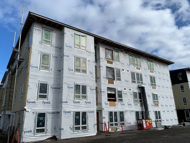 A large building with a lot of windows is being built.