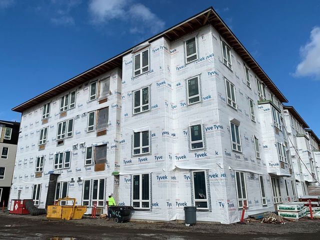 A large building with a lot of windows is being built.