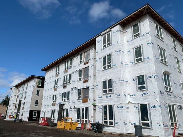 A large apartment building is being built with a lot of windows.