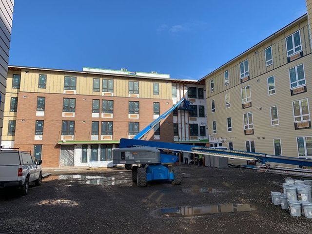A large building with a lot of windows is under construction.