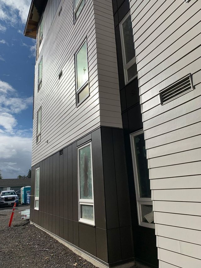 A large building with a lot of windows and a lot of siding.