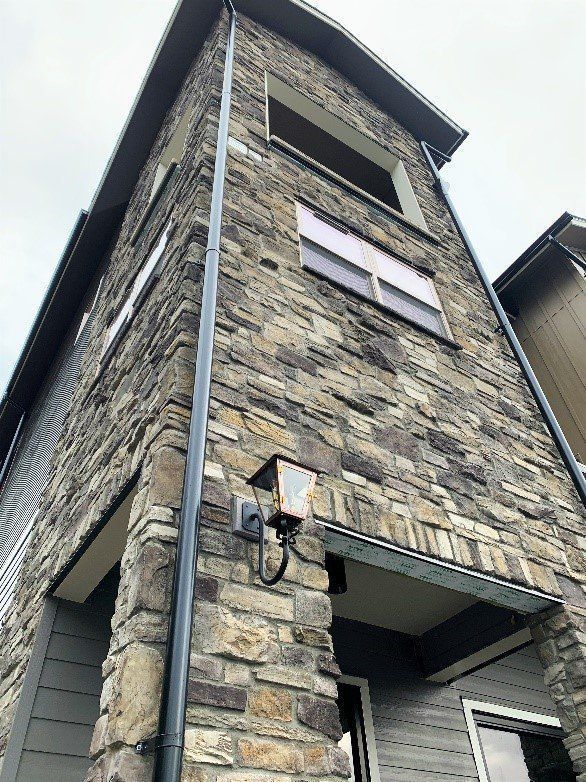 A brick building with a light on the side of it.