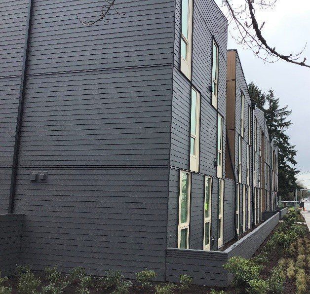 A building with a lot of windows and a tree in the background