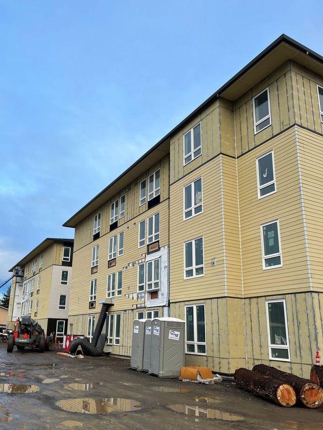 A large building with a lot of windows is under construction