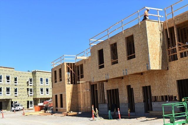 A building under construction with a blue sky in the background