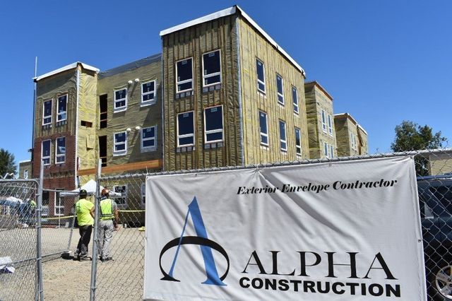 A construction site with a sign that says alpha construction