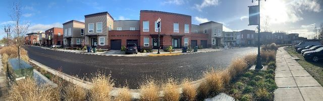 A panoramic view of a row of houses on a sunny day.