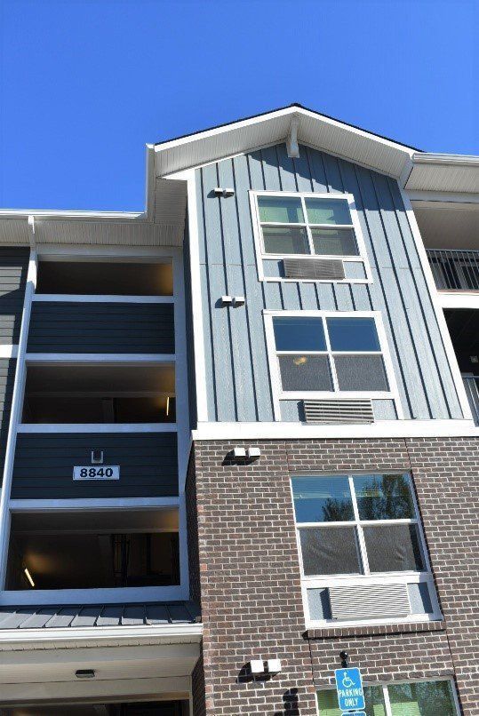A large apartment building with a lot of windows and balconies.