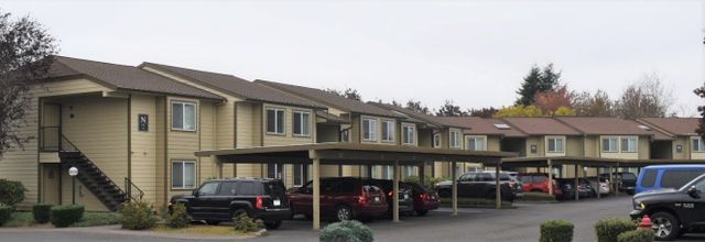 A building with a lot of cars parked in front of it