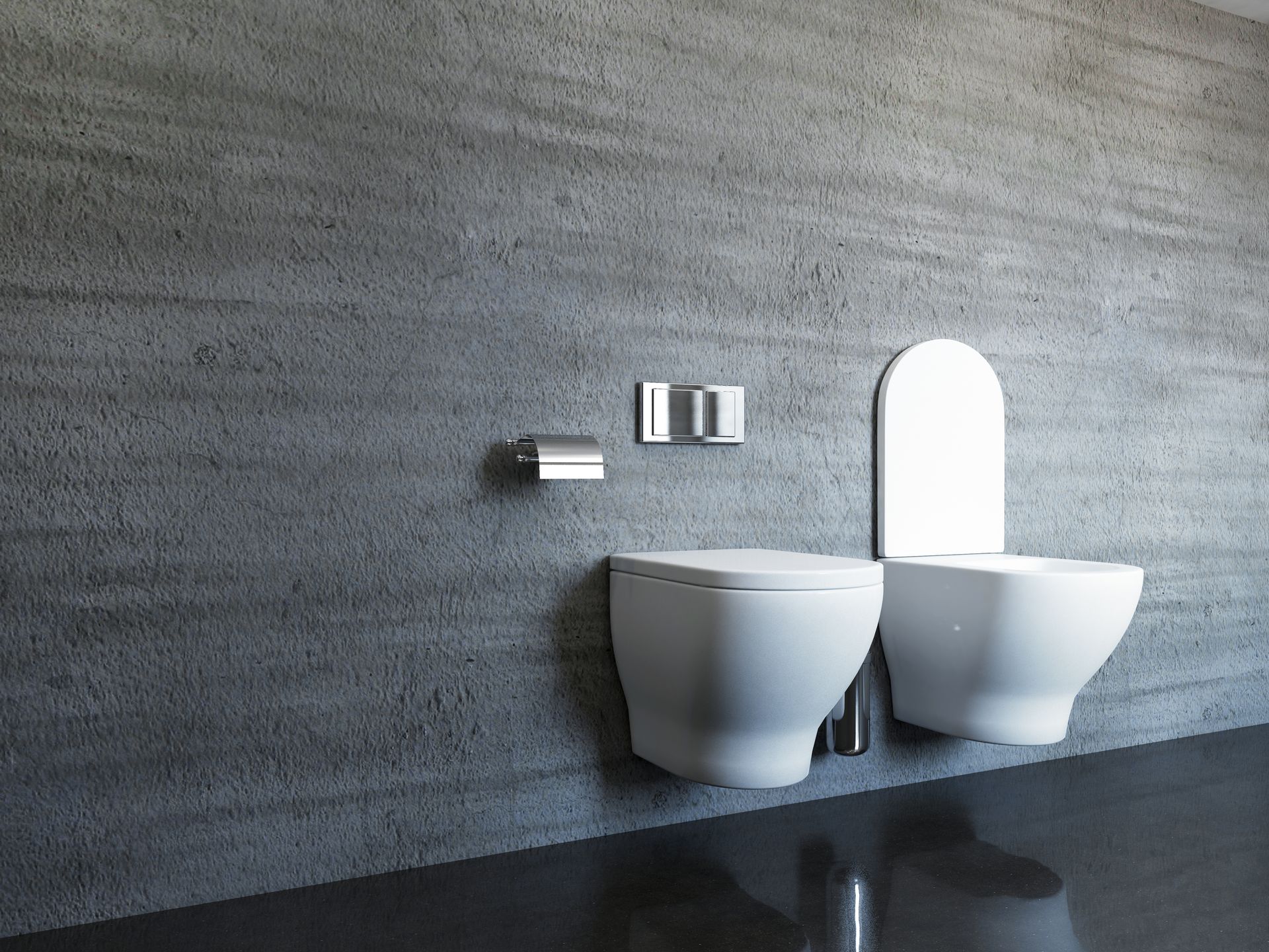Un bagno con WC e bidet contro un muro di cemento