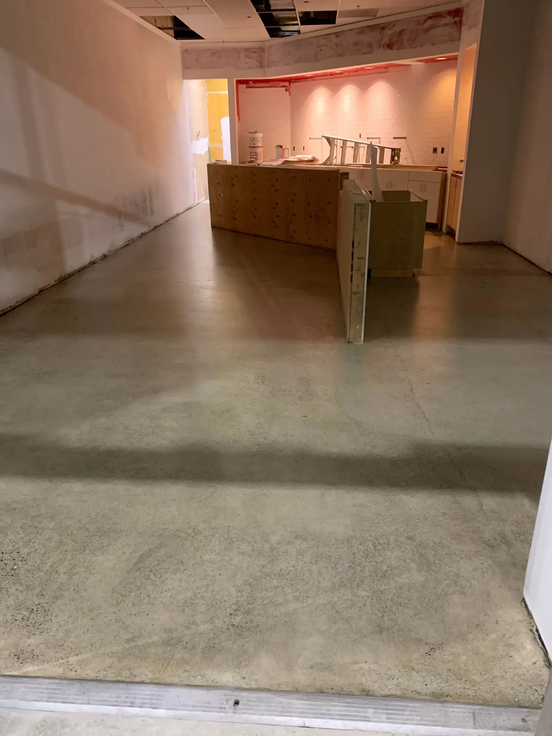 Concrete floor and unfinished walls of a commercial interior.