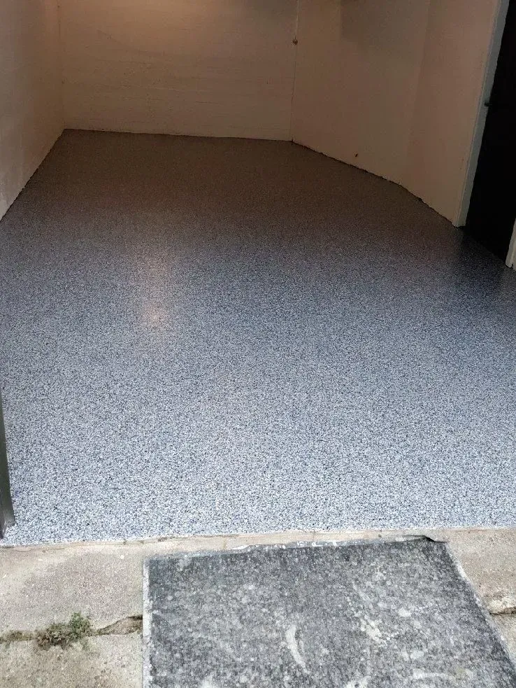 A small room with a speckled blue floor.
