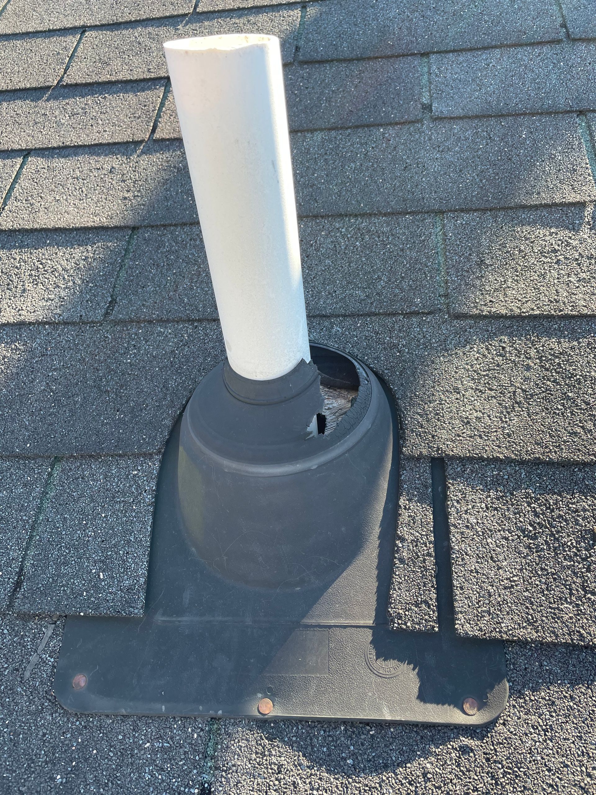 Failed pipe boot around a roof penetration showing deterioration that can allow water intrusion into the roofing system.