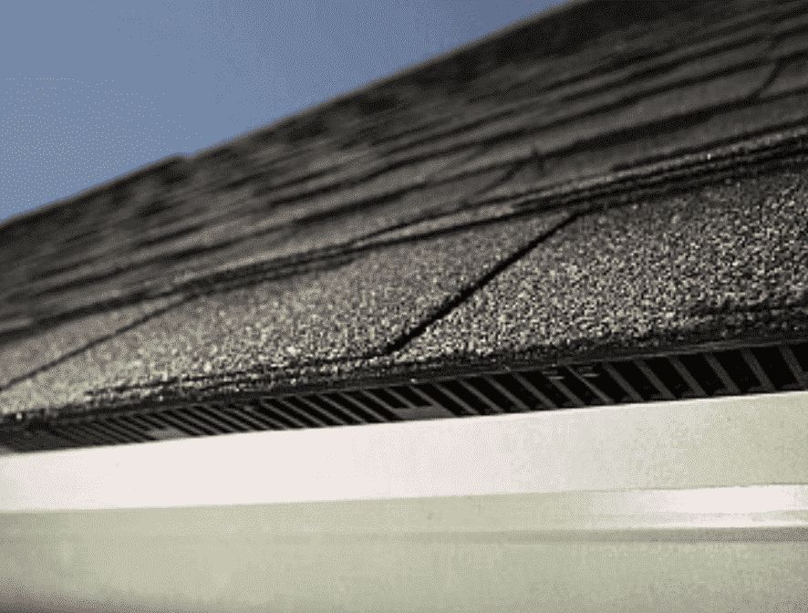 Installed roof intake ventilation along the eave of an asphalt shingle roof to improve attic airflow.