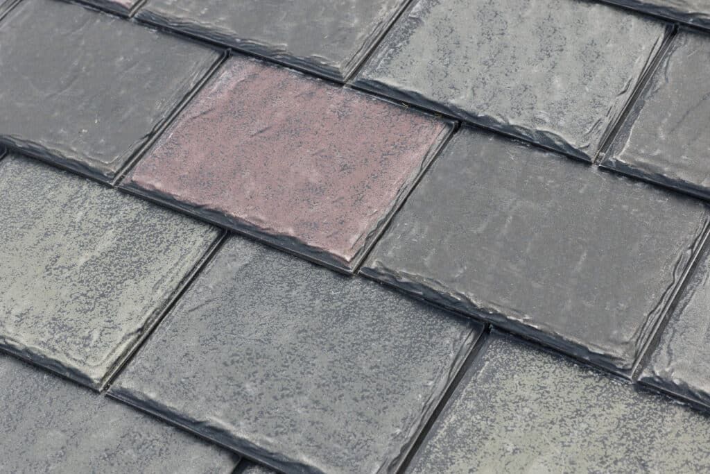Close-up of synthetic roofing shingles designed to replicate the appearance of slate or cedar with engineered durability.