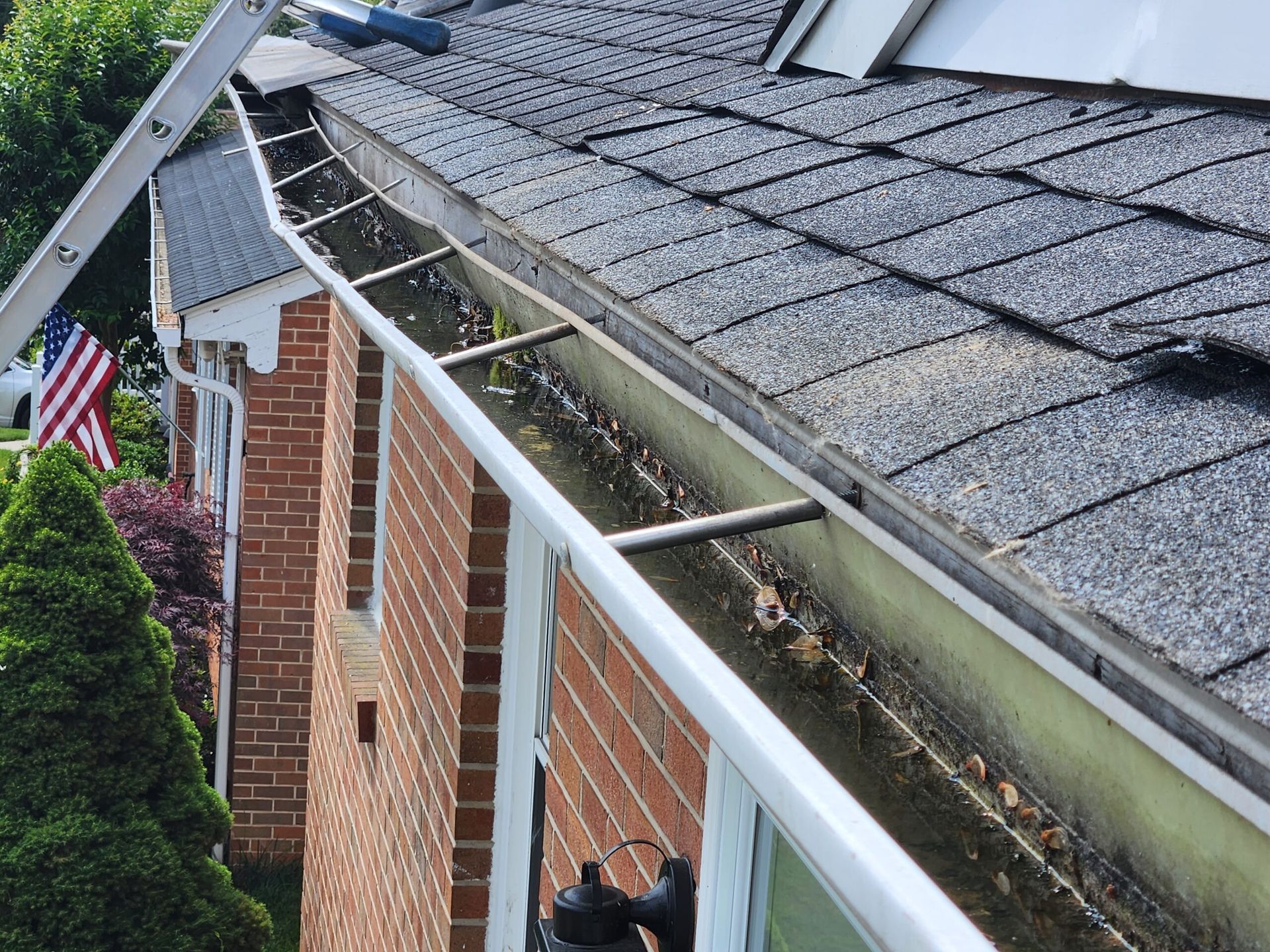 Residential gutter system showing wear and conditions that may require replacement