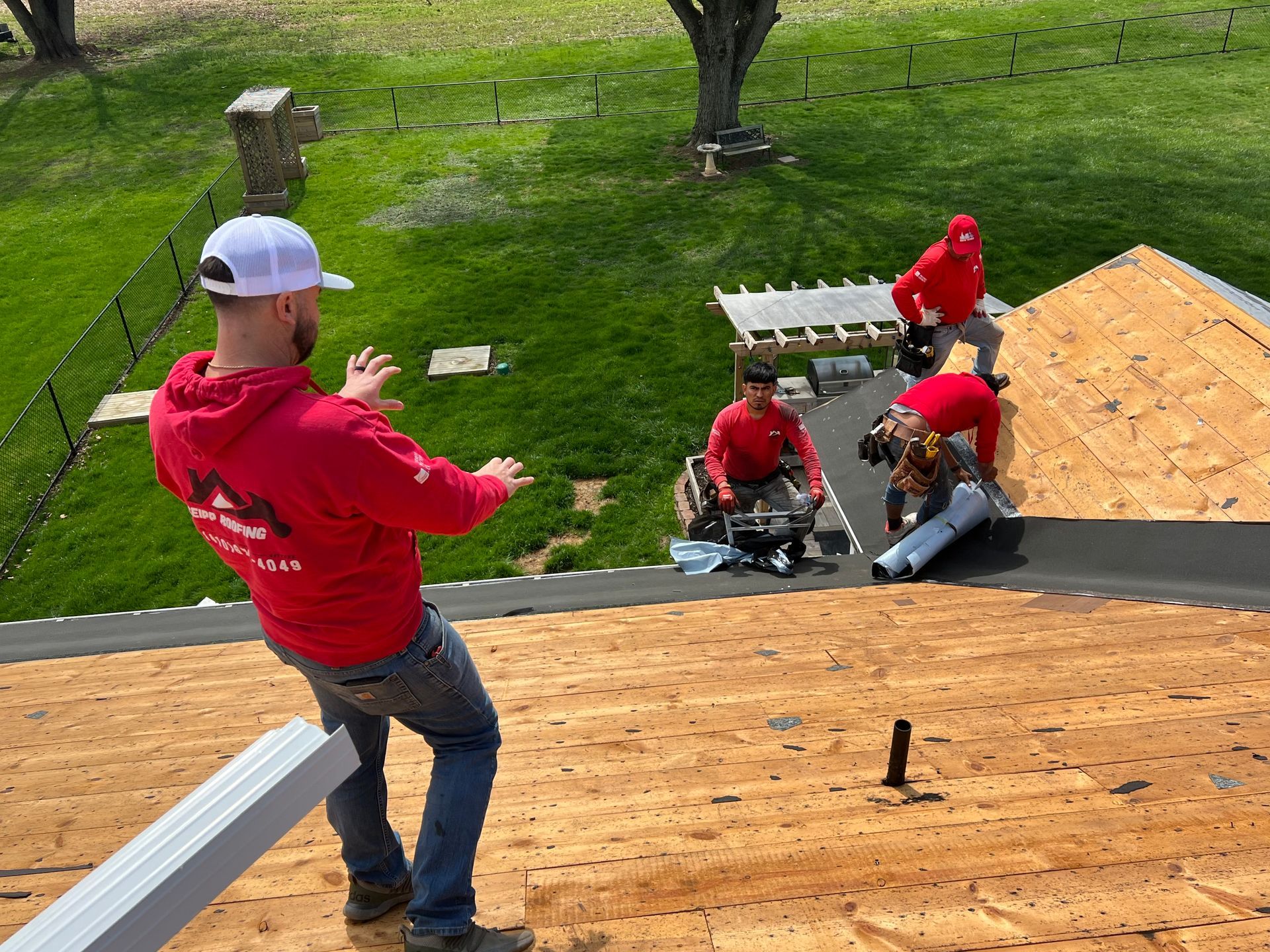 Tyler Seipp directing the roofing crew during a residential roof replacement project.