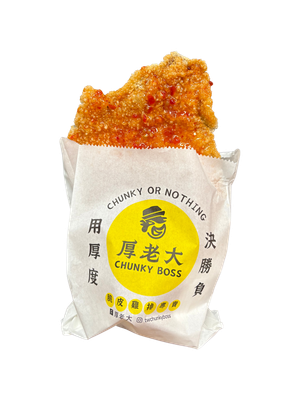 Fried chicken cutlet in paper bag with Chinese text.