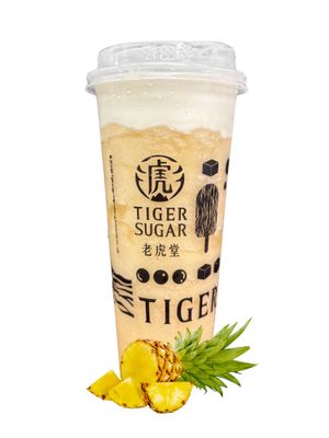 Tiger Sugar pineapple drink with a lid, foam, and pineapple slices.
