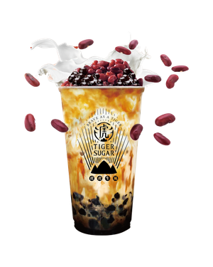 Tiger Sugar brown sugar boba drink with red beans, whipped cream, and scattered red beans.