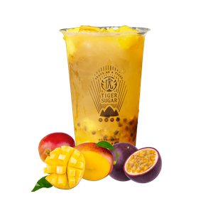 Mango passion fruit bubble tea in a clear cup, surrounded by mangoes, passion fruits, and a red apple.