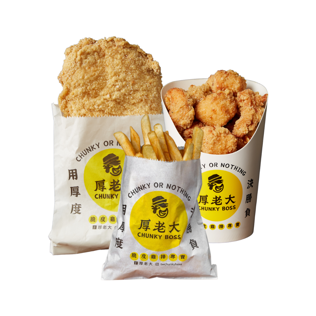 Fried chicken, fries, and popcorn chicken in paper bags with a logo.