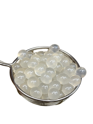 Clear, translucent boba pearls in a silver mesh strainer.