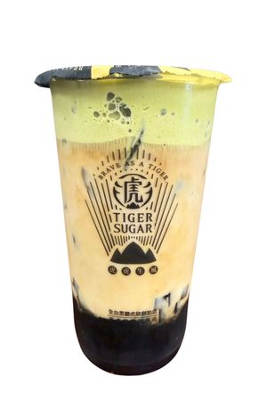 Taro milk tea with boba, a purple pudding cup, and splash. Tiger Sugar branding visible.