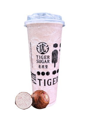 Taro milk tea in a clear cup with logo and two taro root bulbs in front.
