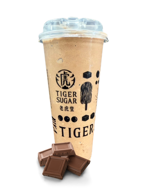 Tiger Sugar chocolate drink in a cup, with chocolate pieces in front.