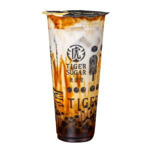 Tiger Sugar brown sugar boba drink in a clear plastic cup. Caramel streaks, dark boba at bottom.