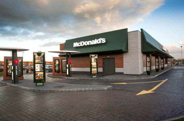 A mcdonald 's restaurant with a green awning