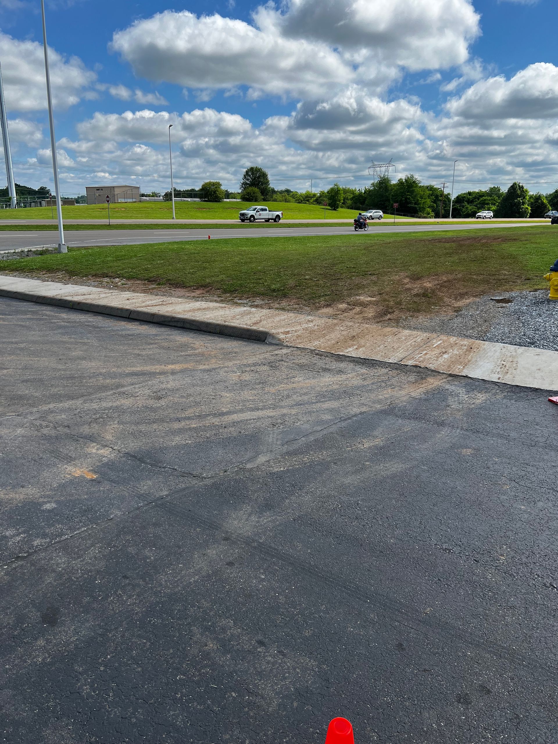 A road with a red cone in the middle of it