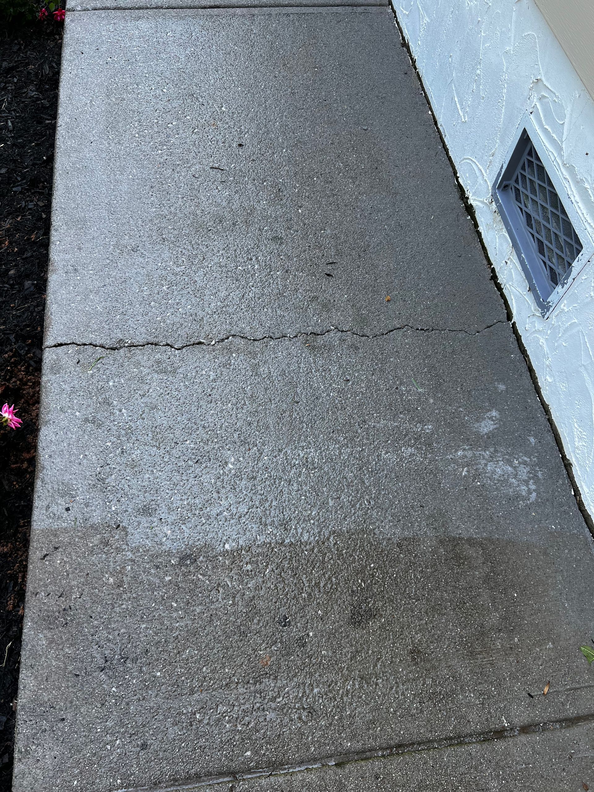 A close up of a concrete sidewalk next to a building.