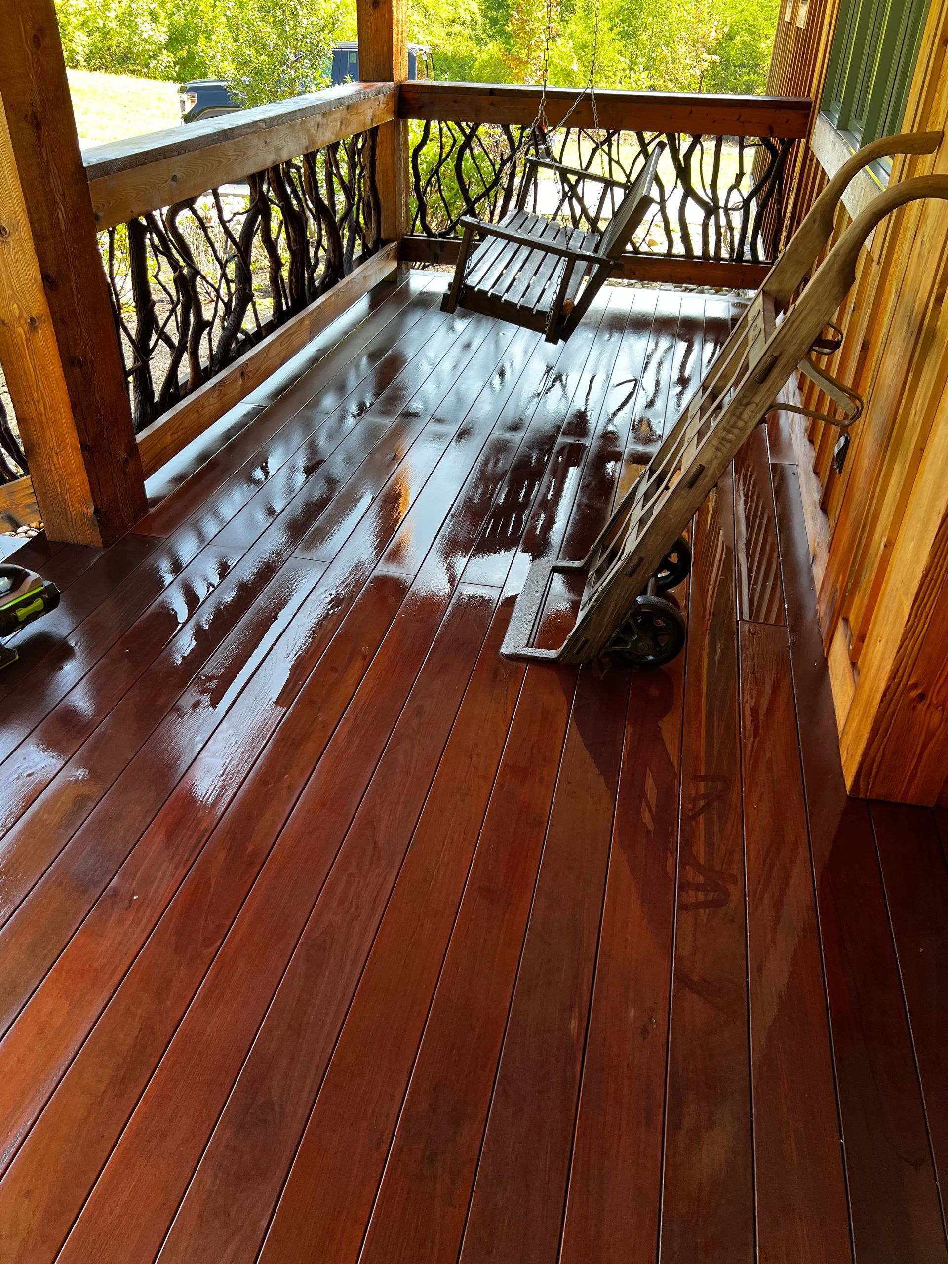 A wooden deck with a vacuum cleaner on it.