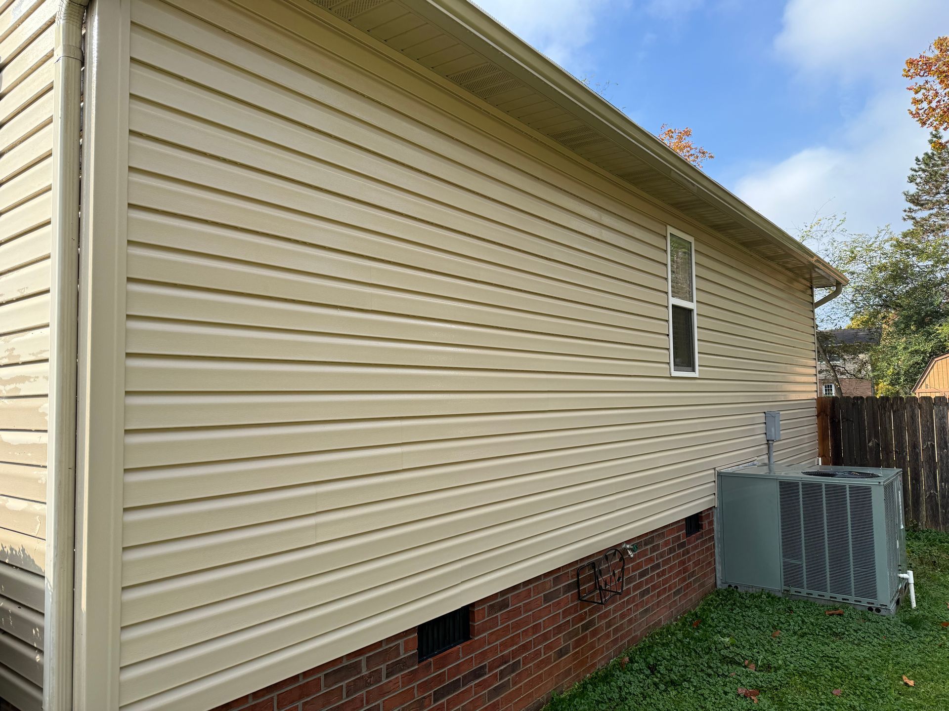 The side of a house with siding and a window.Job done by 865 Power Wash