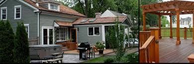 A house with a pergola and a wooden deck