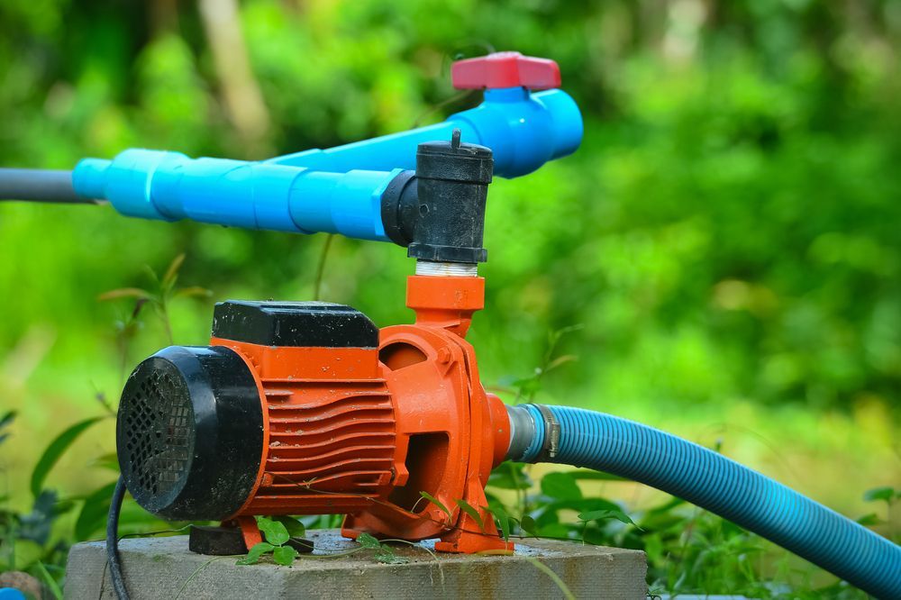 A Close Up of a Water Pump With a Hose Attached to It — Davidson's Electrical In Parkhurst, QLD