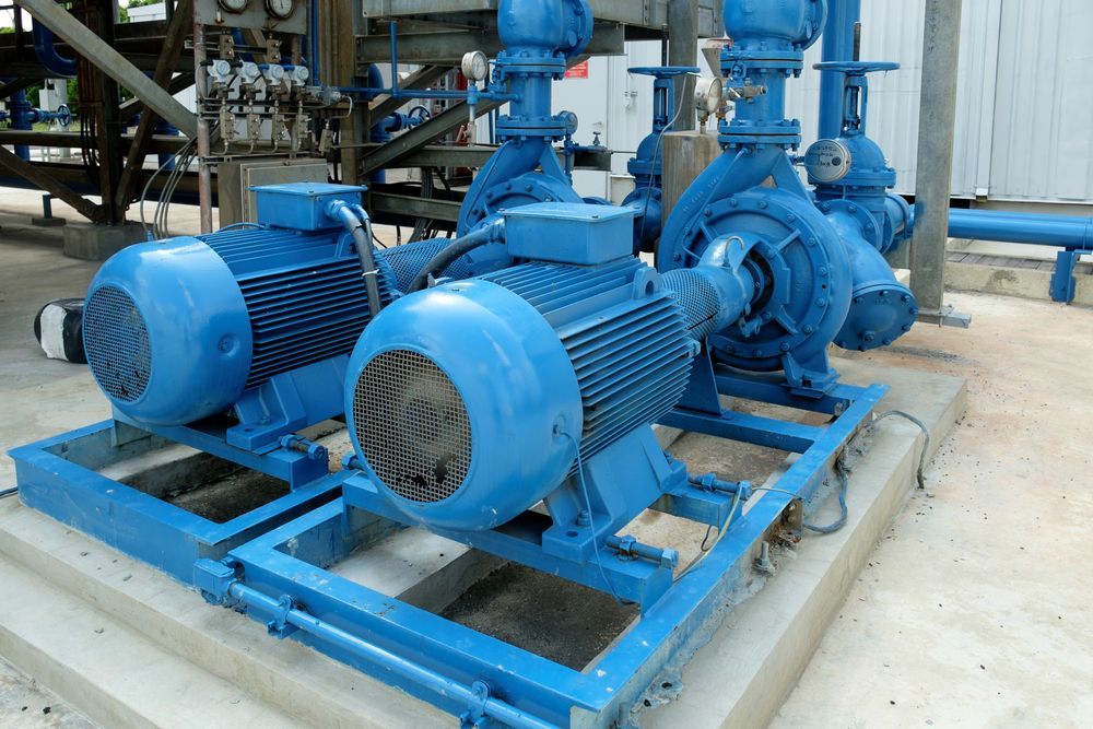 Blue industrial pumps and motors on a platform, possibly for water or liquid transfer— Davidson's Electrical In Parkhurst, QLD