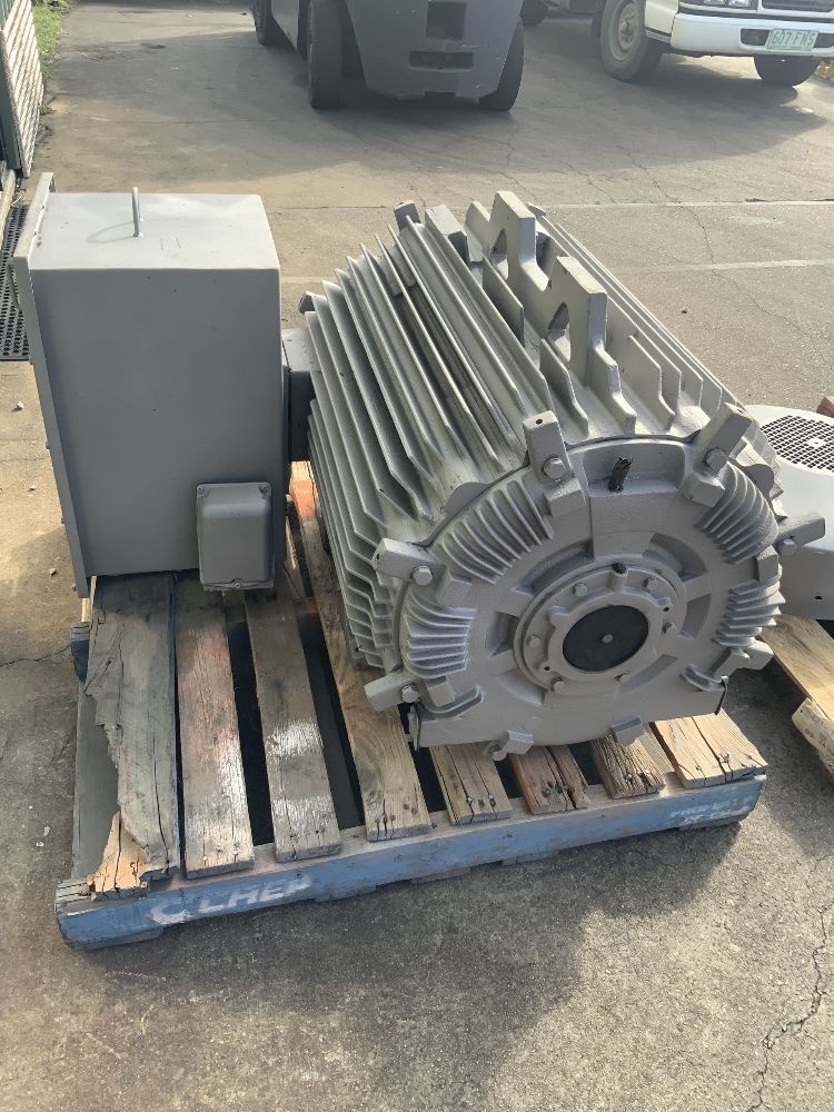 A large electric motor is sitting on top of a wooden pallet — Davidson's Electrical In Parkhurst, QLD